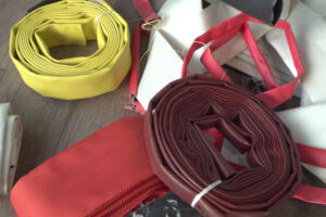 Aufgewickelte Feuerwehrschläuche in verschiedenen Farben
