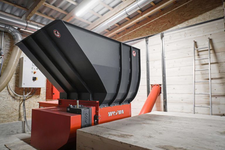 wood waste shredder in a wood shop with flared hopper