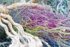 Different types of colorful fishing nets, ropes and other fibers