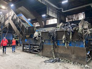 Agricultural film on the shredder conveyor belt