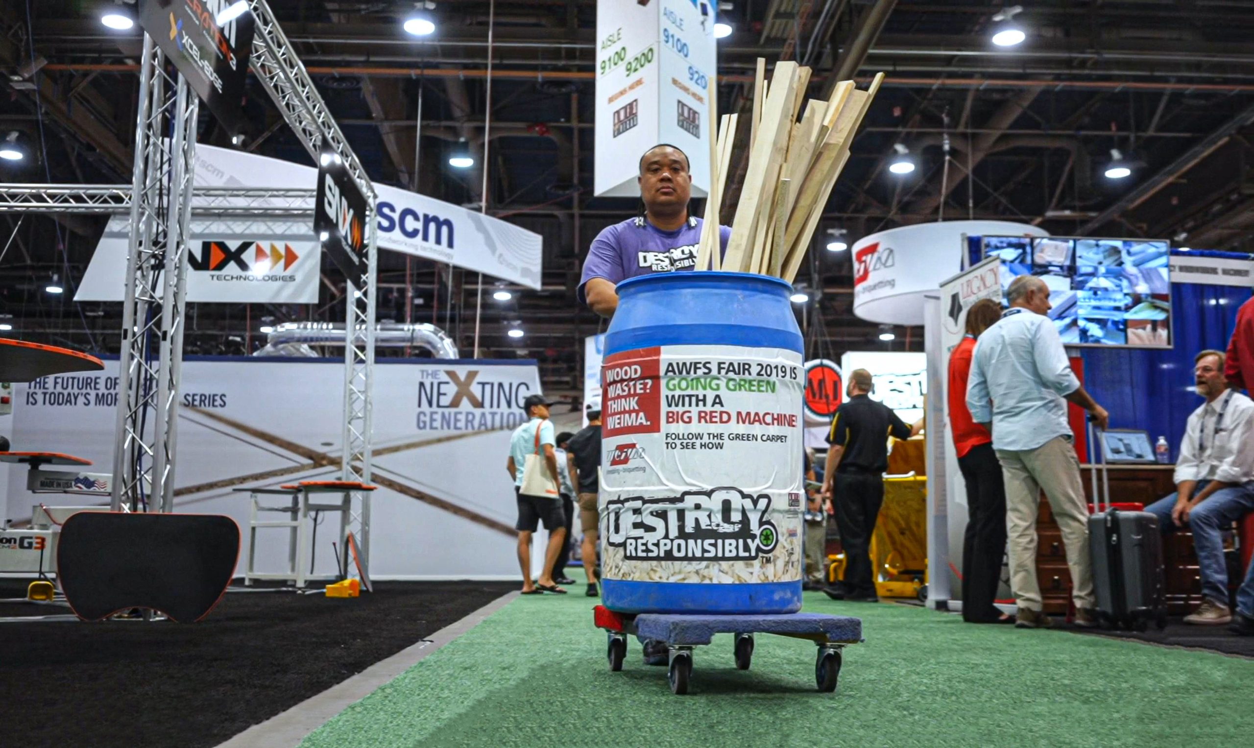 Freeman worker collects wood waste on the tradeshow floor