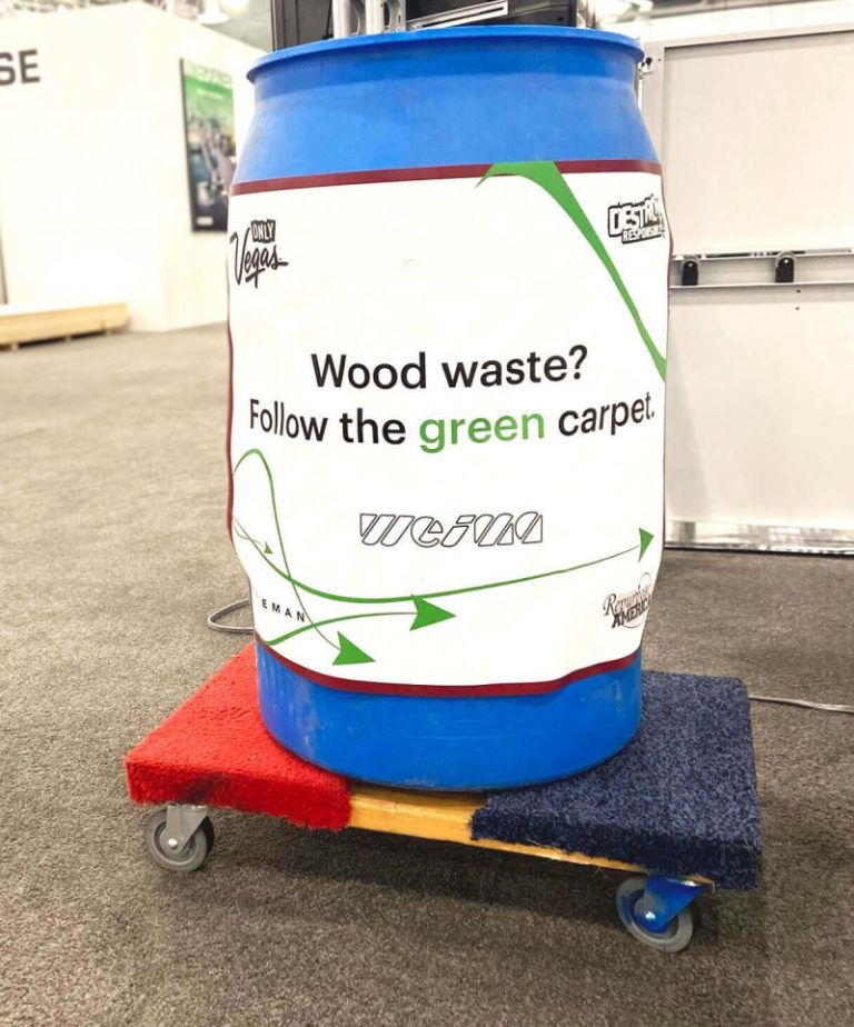 A blue barrel is used for the picking up of wood waste from the tradeshow floor and taking it to the shredding system out back.
