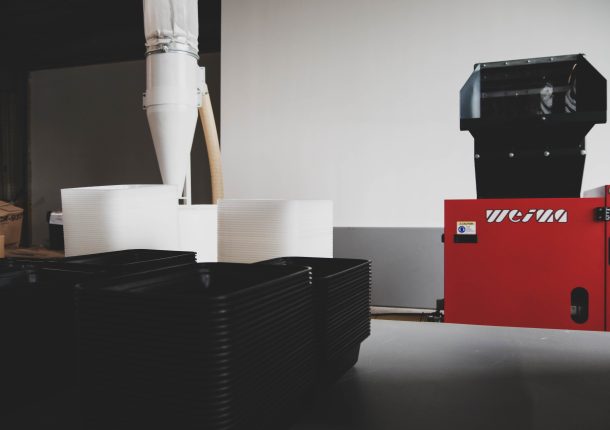 a view of the granulator connected to the air system. the product being shredded sits in the foreground.