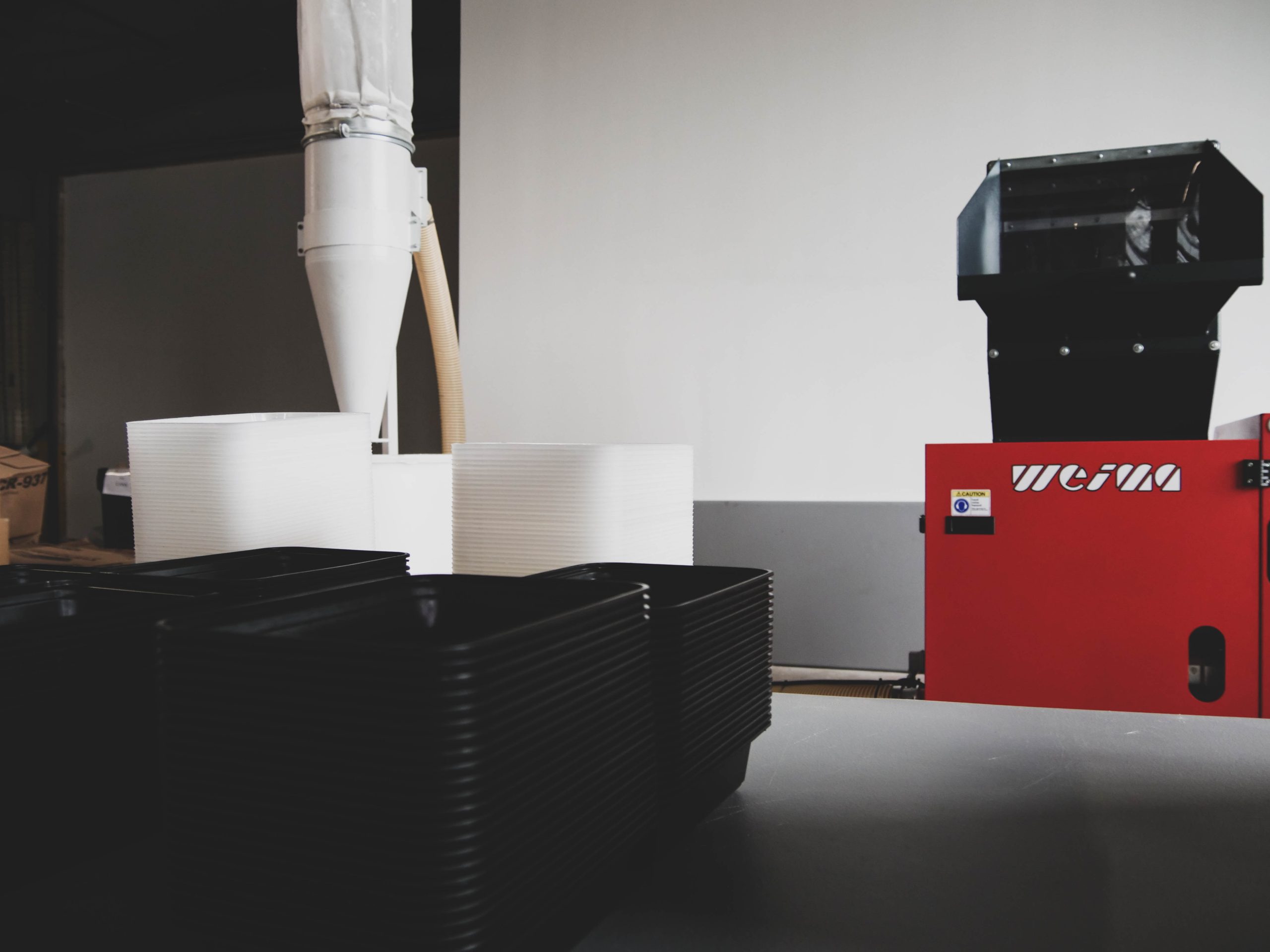 a view of the granulator connected to the air system. the product being shredded sits in the foreground.