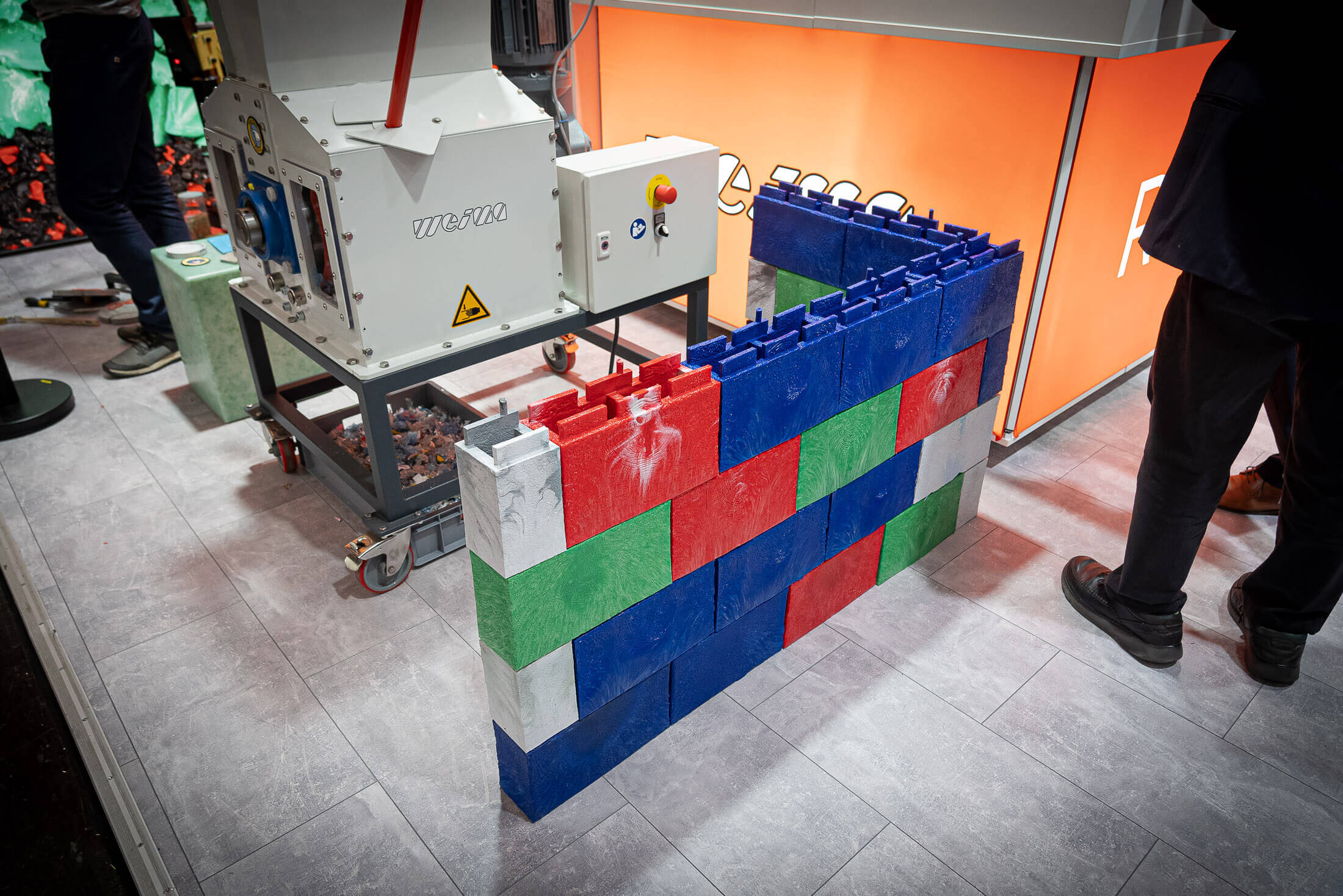 colorful recycled bricks form a wall on the WEIMA K show booth