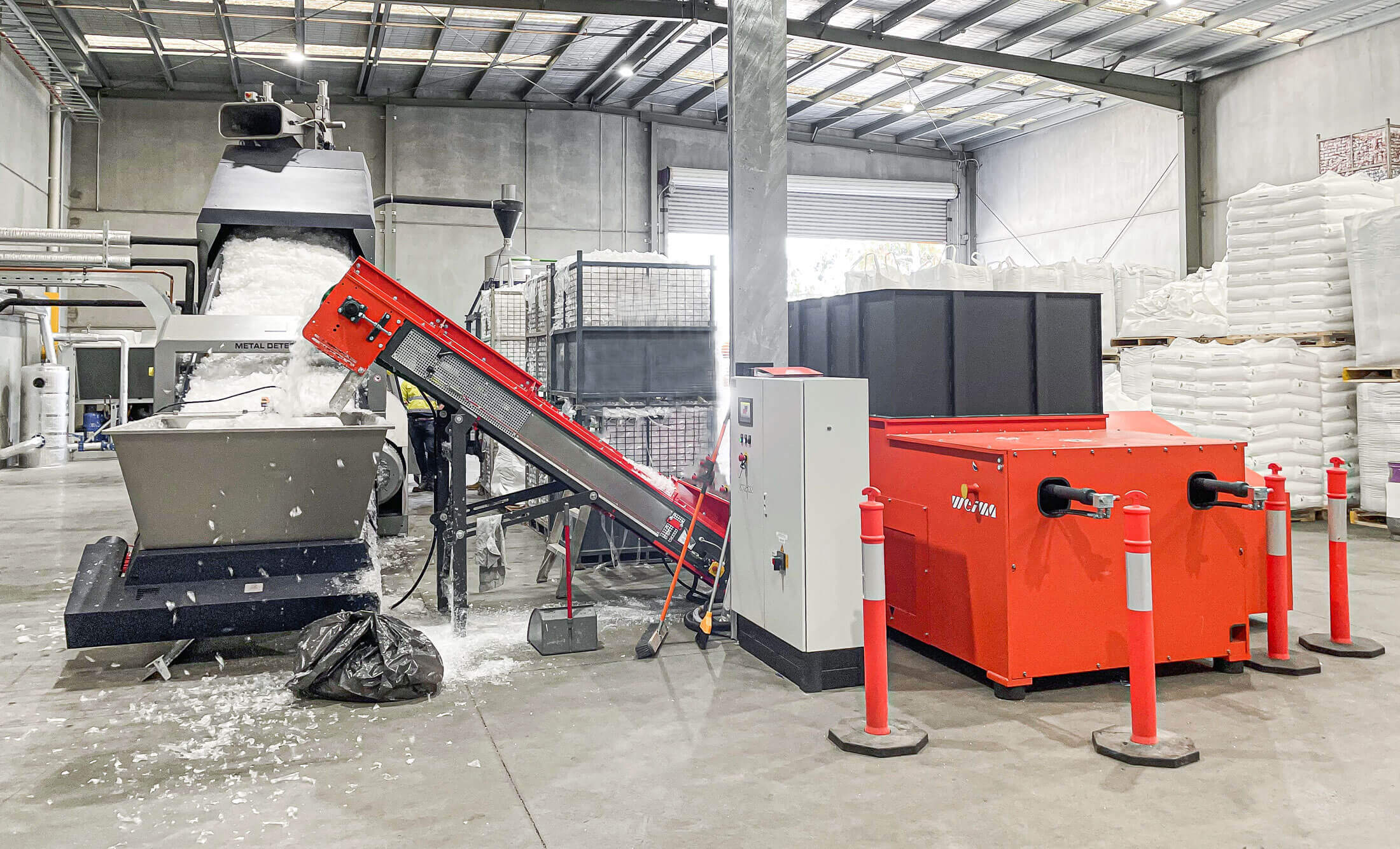 orange weima shredder next to a blue erema extrusion system for film recycling