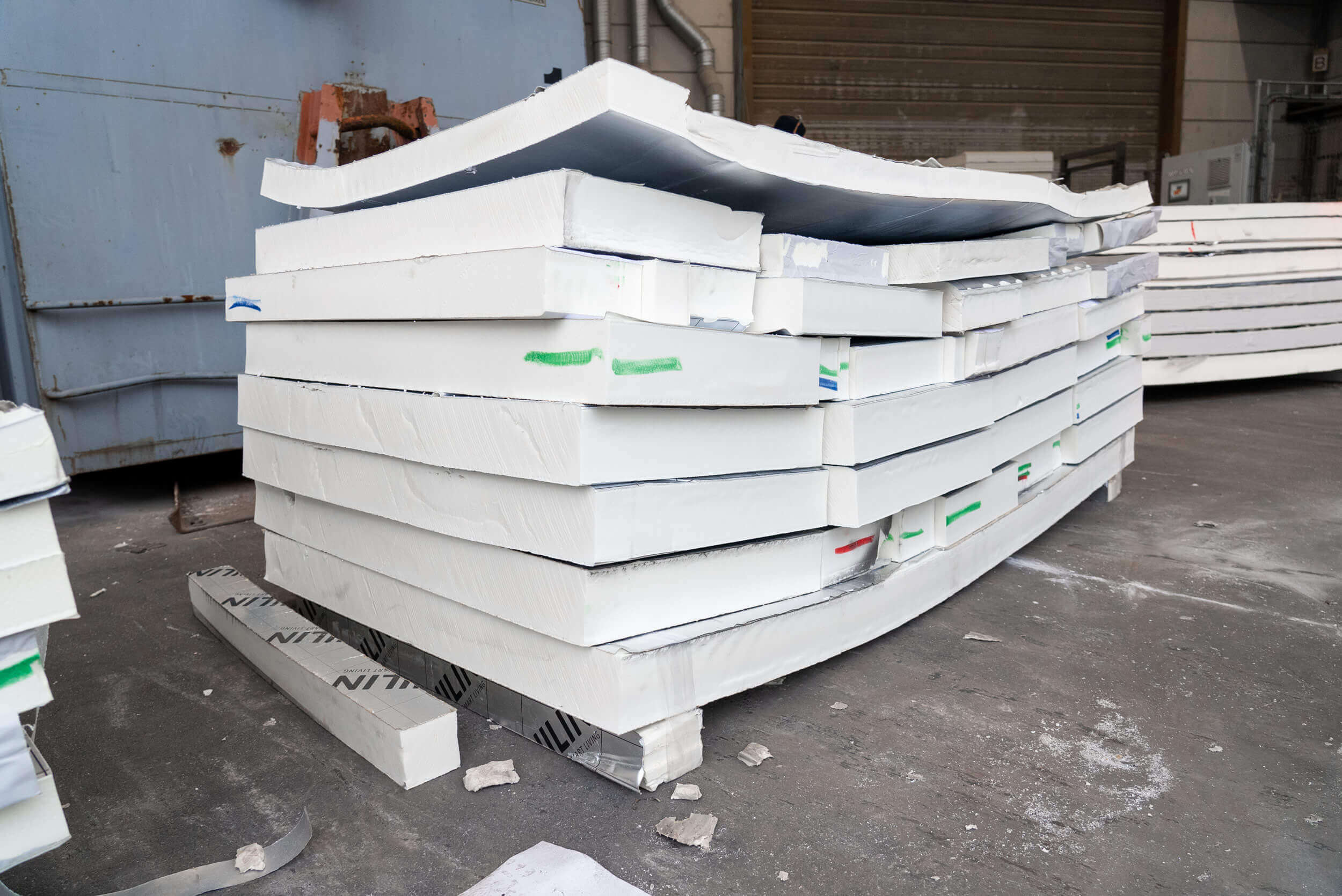 Stack with sorted UNILIN PU foam insulation boards before shredding with WEIMA
