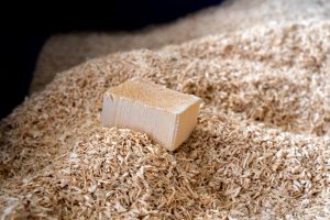 A piece of wood on a pile of wood chips