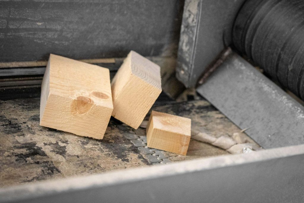 3 pieces of wood on a conveyor belt
