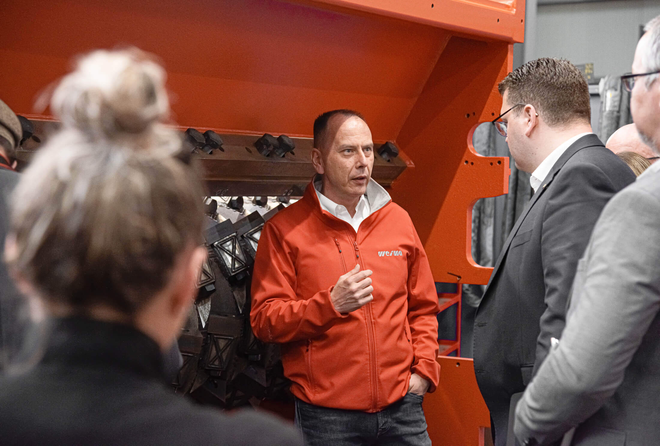 Oliver-Werner Sadrinna, Head of Supply at WEIMA, surrounded by other people in front of a WEIMA shredder