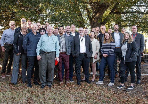 The Sustainability & Recycling Committee poses with some WEIMA employees for a group photo in the beer garden.