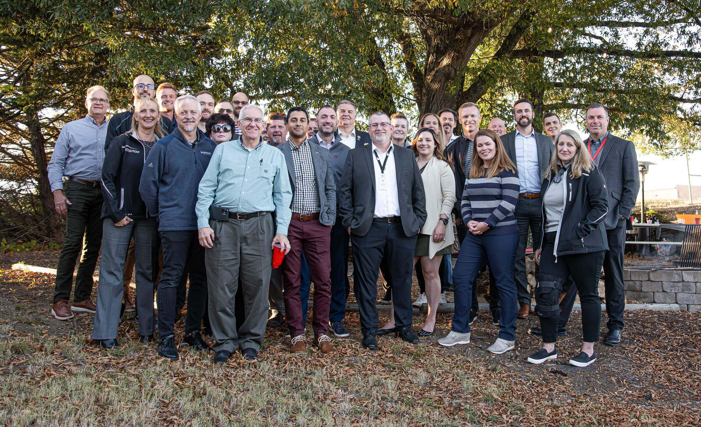 The Sustainability & Recycling Committee poses with some WEIMA employees for a group photo in the beer garden.