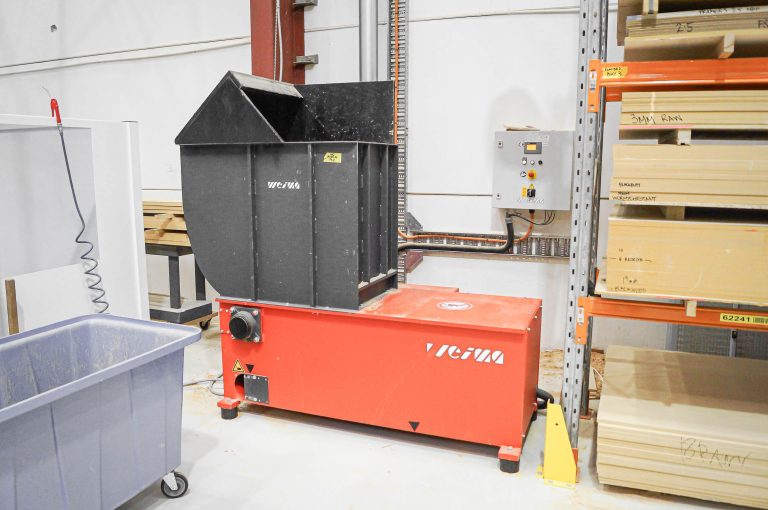 a red-orange shredder from WEIMA in a industrial hall