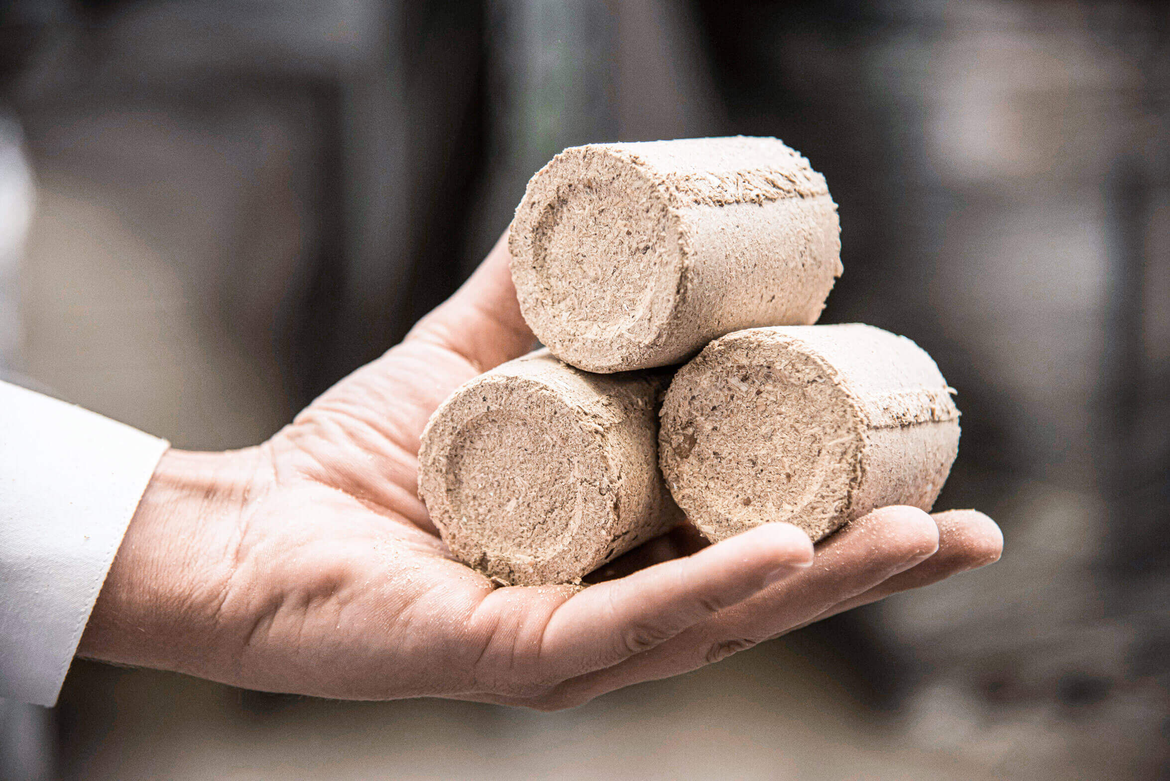 Round briquettes made from wood chips are easy to handle
