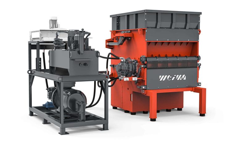 Power Pack of a hydraulic drive from Hägglunds next to an orange WEIMA shredder
