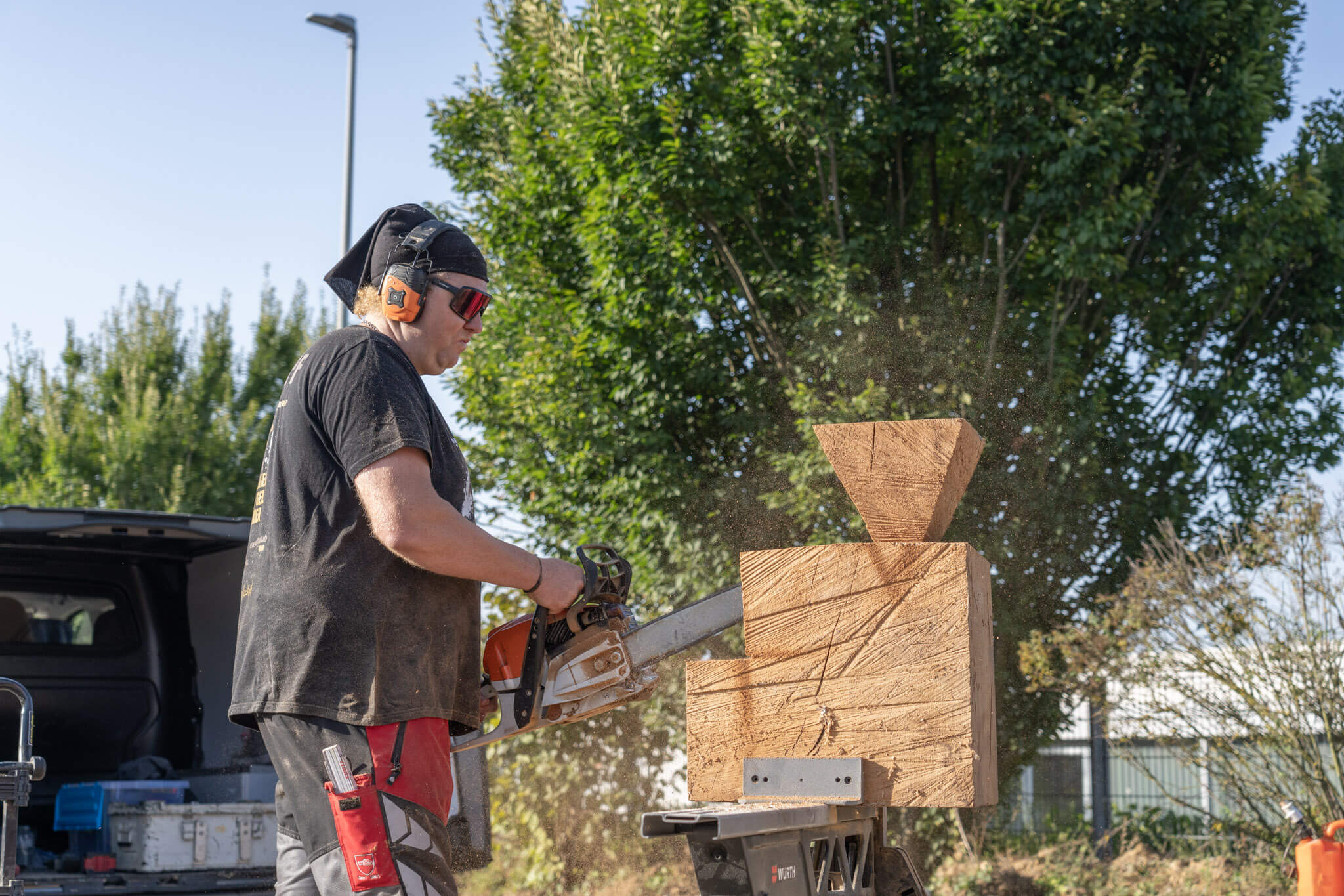 Locke saws a sculpture out of wood