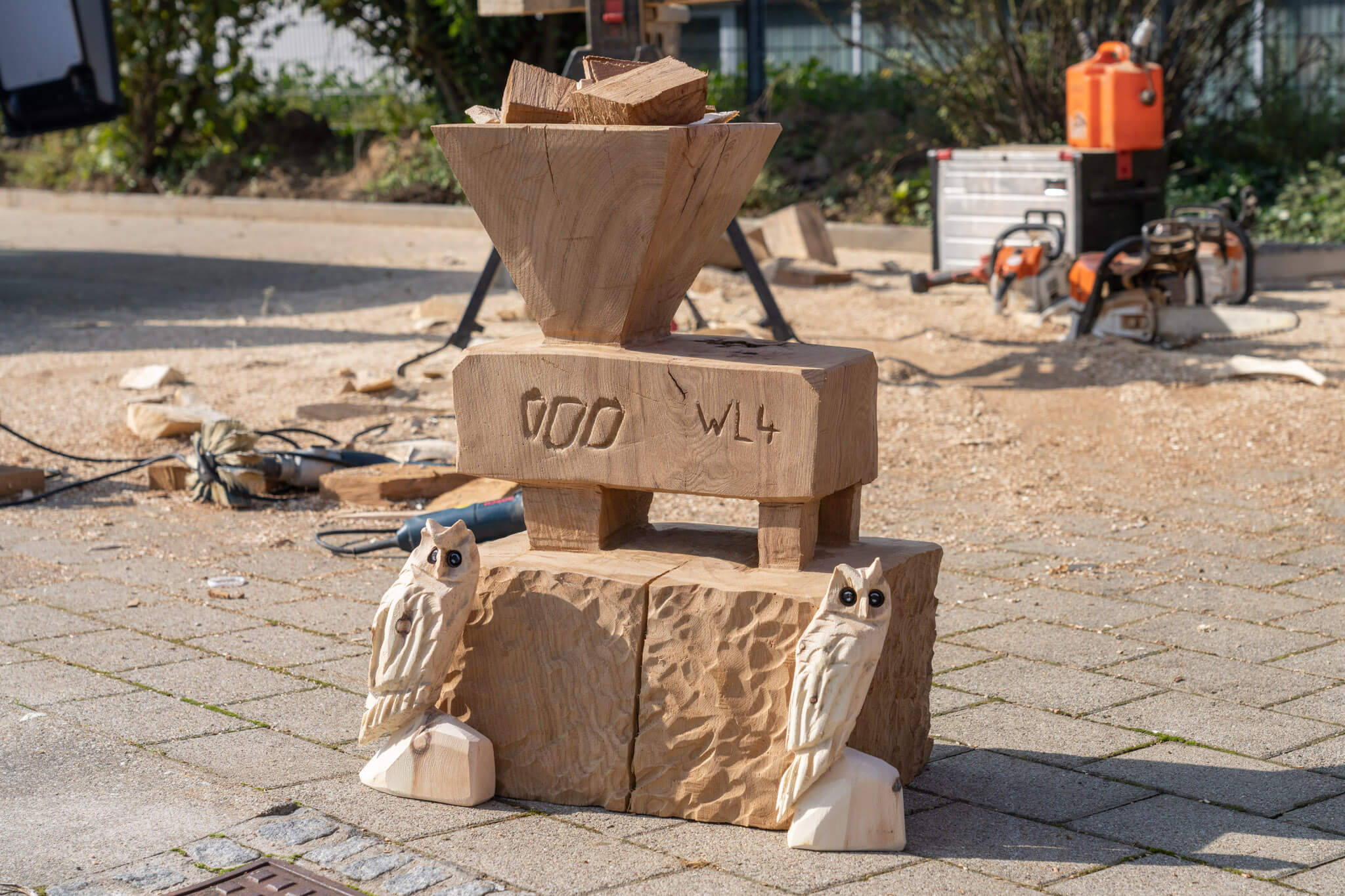 Figures carved from wood, two owls and a WEIMA shredder