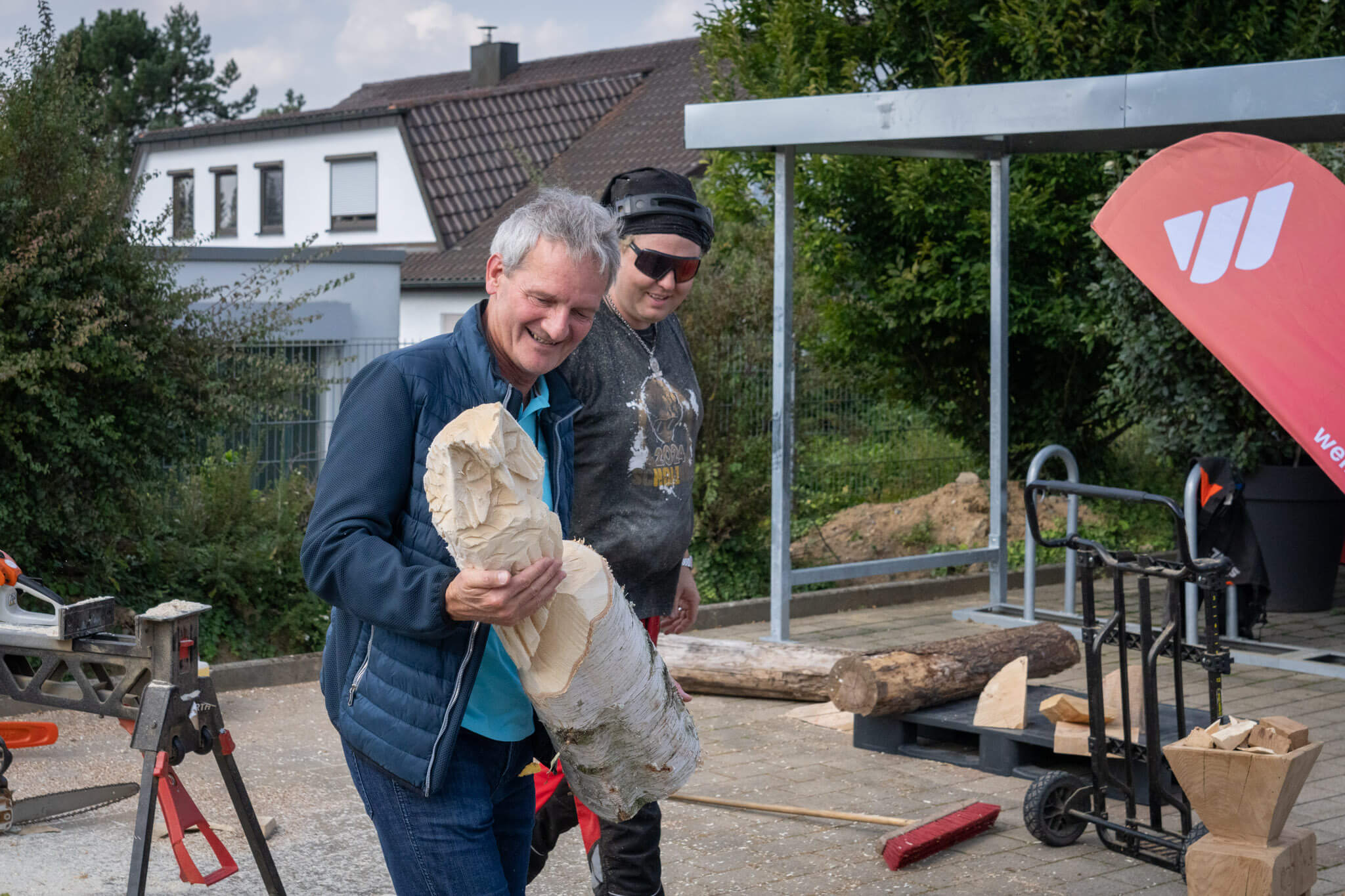 A participant is delighted with a carved owl