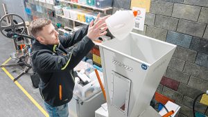 A WEIMA employee feed the Shredder Pro with post-consumer plastics for shredding