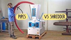 Man with red pipe standing in front of WEIMA shredder Pro to throw pipe into the shredder for testing