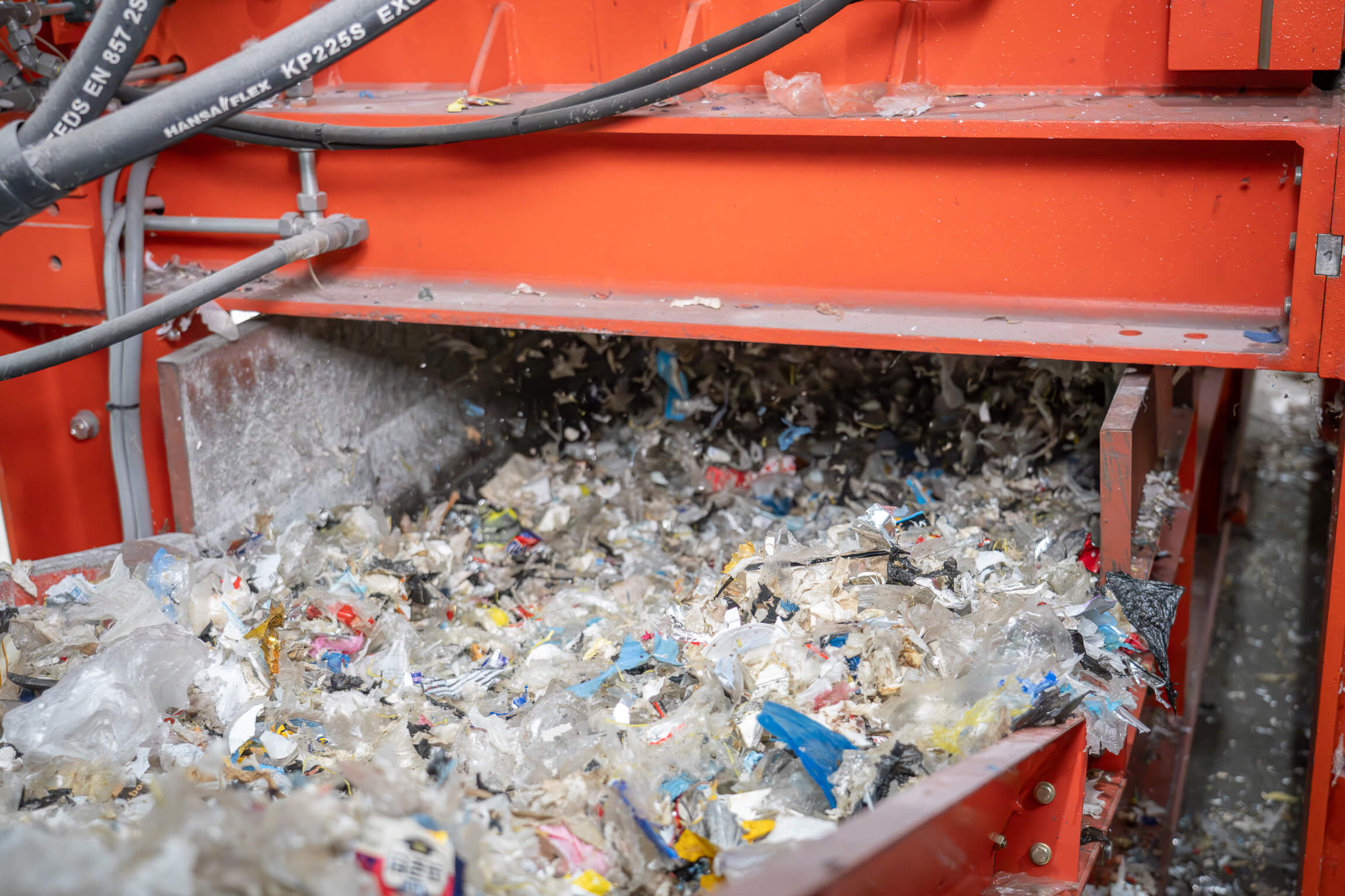 View of the conveyor belt with shredded material coming out of the shredder.