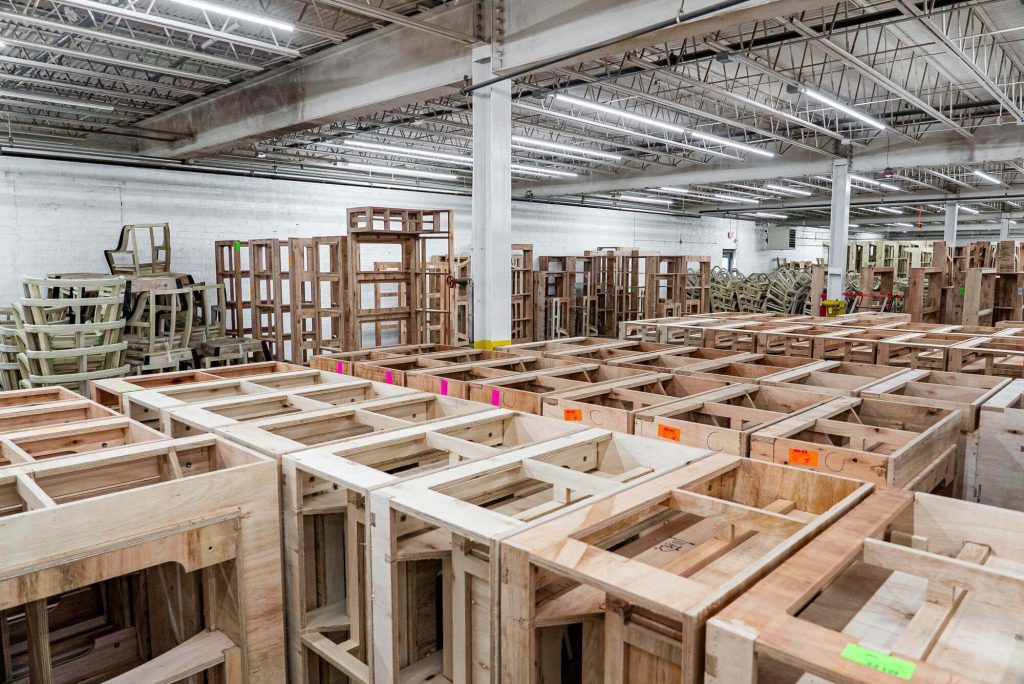 Assembled furniture is organized neatly in a warehouse.