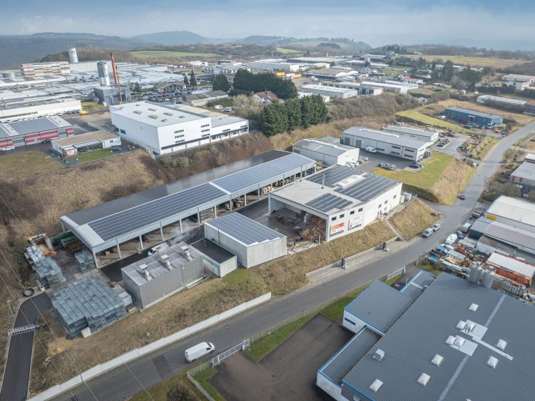Brennholzwerk Trier company premises within an industrial area photographed from the air.