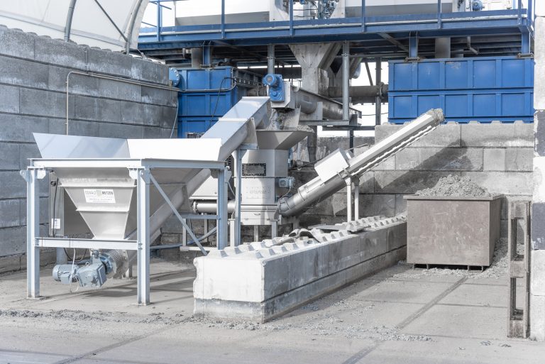 A WEIMA C.200 dewatering press stands in an outdoor installation combined with other machines