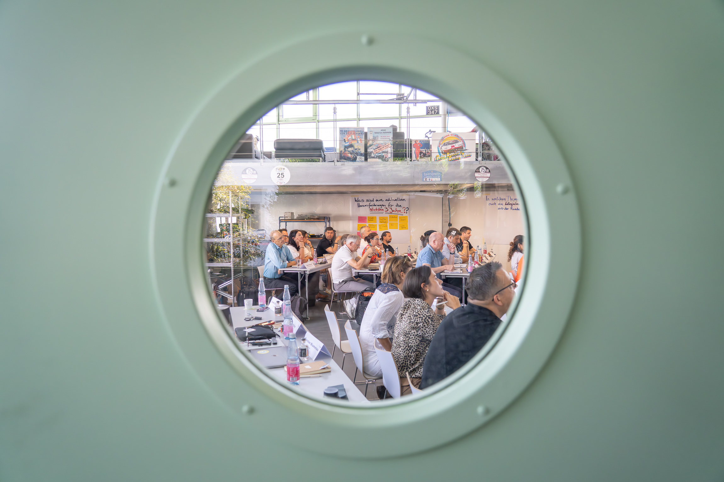 You can see the members listening to the presentations through a porthole