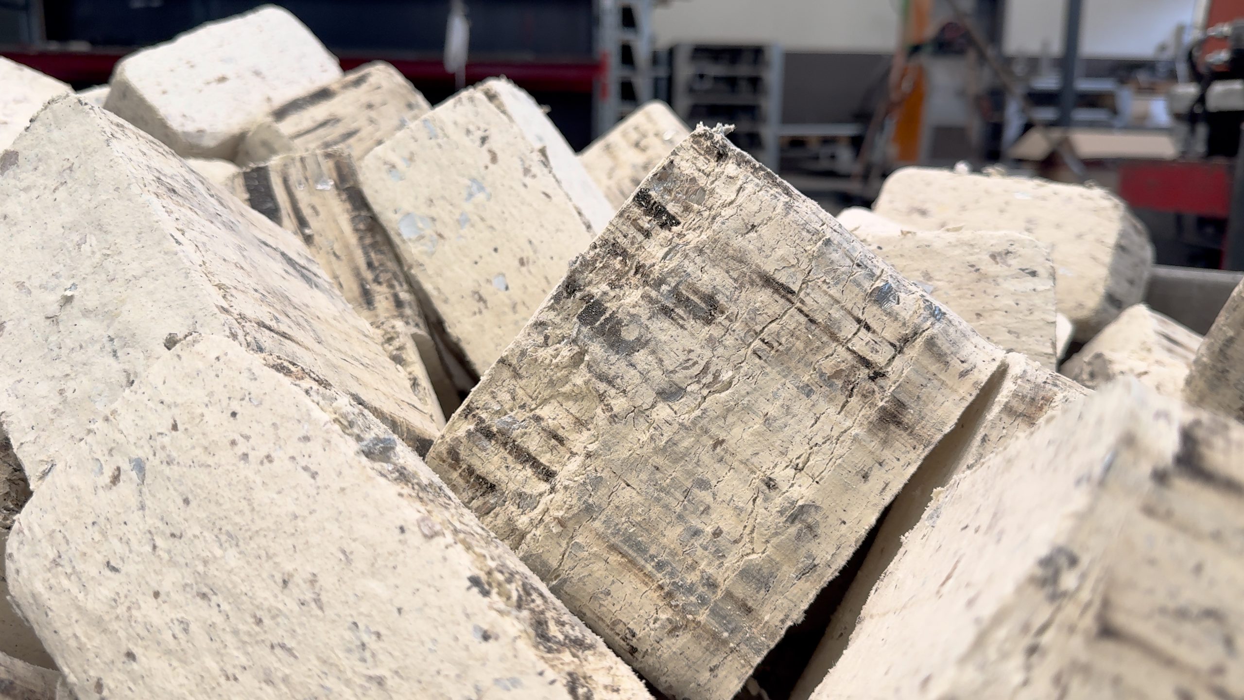 A stack of white, square PU foam briquettes.